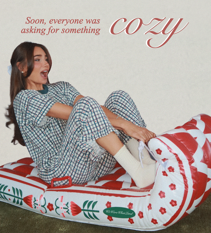Danielle Bernstein sitting on a floral-patterned inflatable sled with text 'Soon, everyone was asking for something cozy' wearing new holiday pajamas