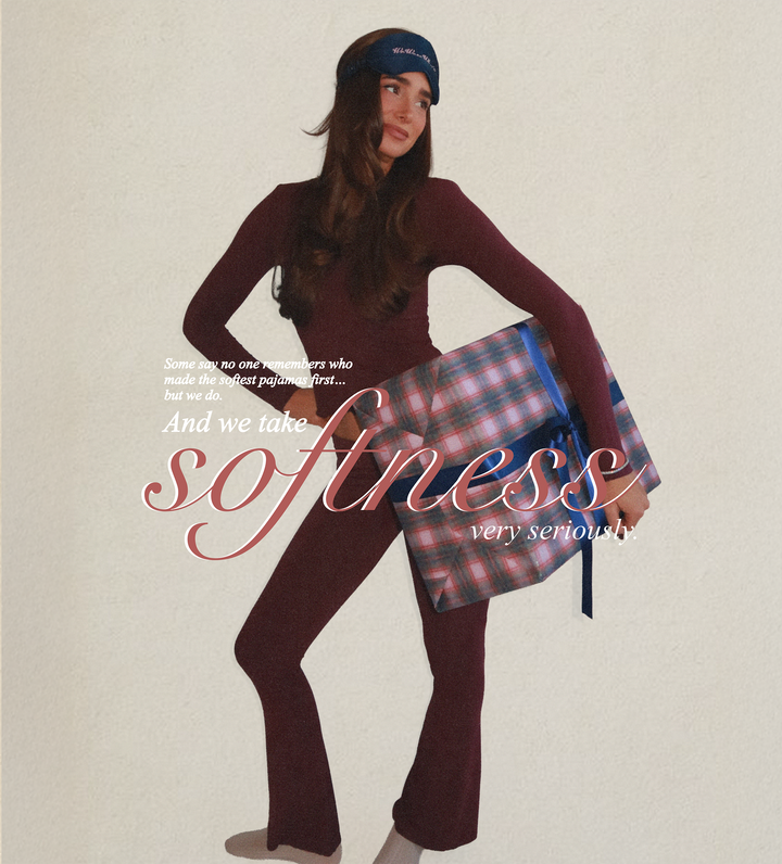 Danielle Bernstein wearing a burgundy pajama lounge set holding a plaid-wrapped gift box with text about softness on a beige background